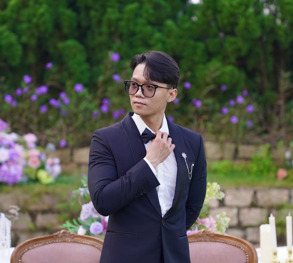 Hung Bui wearing a navy suit outdoors